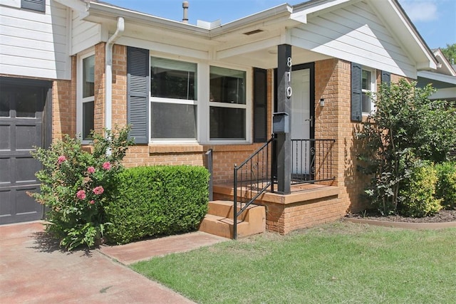 810 S Lahoma Ave, Norman, OK 73069 - entrance to property featuring brick siding, a lawn, and a garage