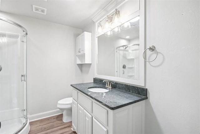 810 S Lahoma Ave, Norman, OK 73069 - bathroom featuring a stall shower, wood finished floors, and vanity