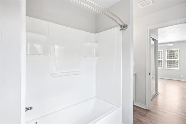 810 S Lahoma Ave, Norman, OK 73069 - full bath featuring tub / shower combination and wood finished floors