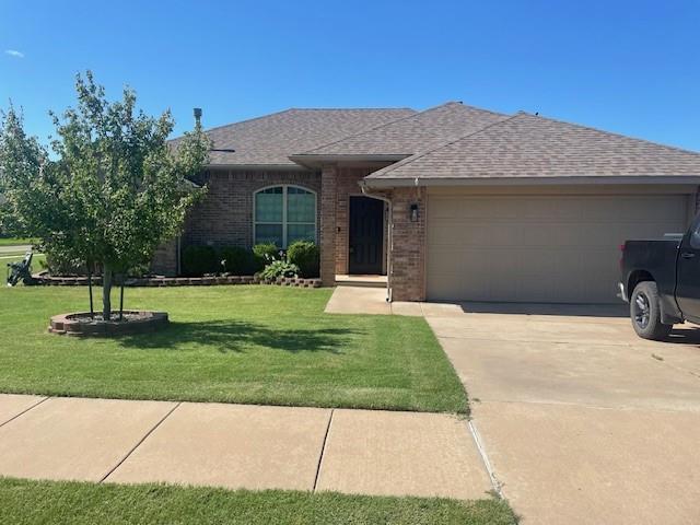 11820 SW 8th St, Yukon, OK 73099 - ranch-style house featuring an attached garage, a shingled roof, concrete driveway, and a front yard