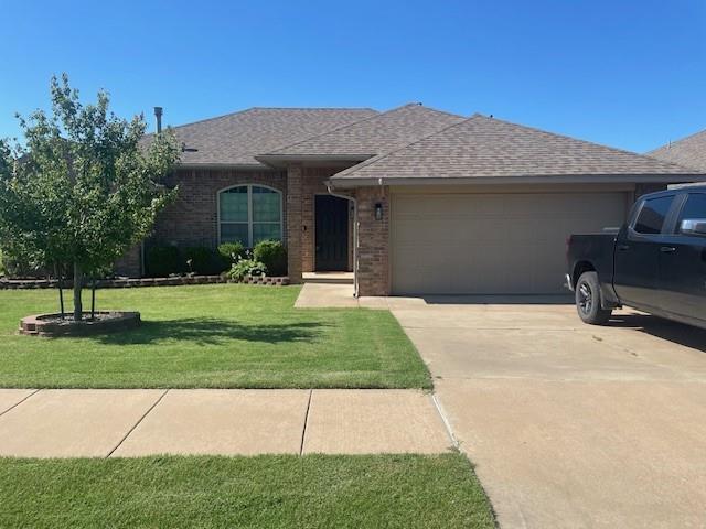 11820 SW 8th St, Yukon, OK 73099 - ranch-style home featuring a garage, driveway, a shingled roof, and a front lawn