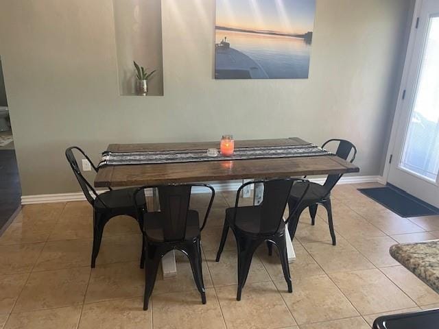 11820 SW 8th St, Yukon, OK 73099 - dining space featuring baseboards and light tile patterned flooring