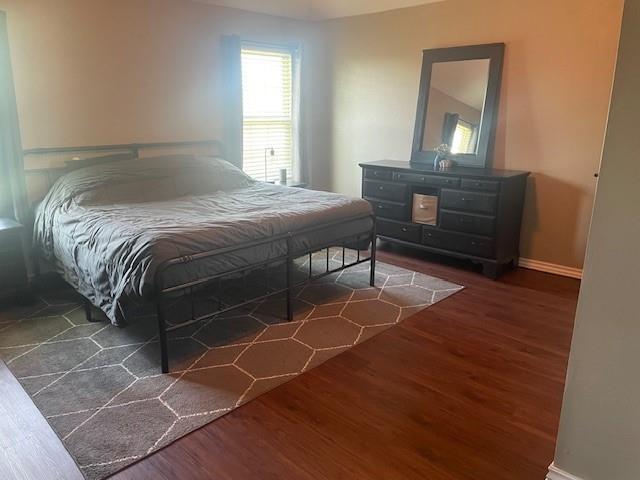 11820 SW 8th St, Yukon, OK 73099 - bedroom with wood finished floors and baseboards