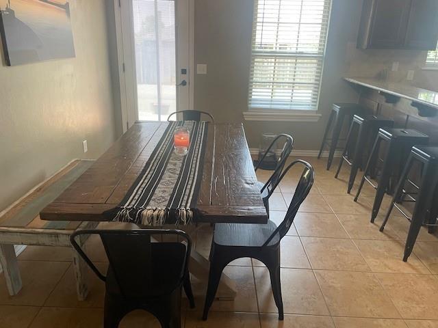 11820 SW 8th St, Yukon, OK 73099 - dining room with light tile patterned floors and baseboards