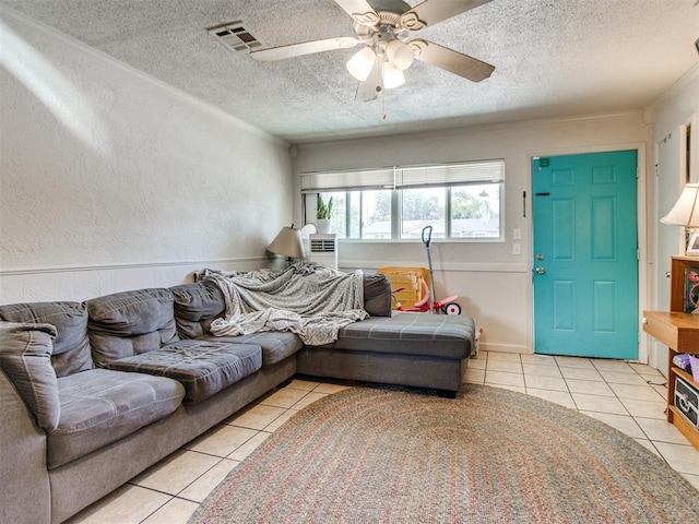 5305 S Drexel Ave, Oklahoma City, OK 73119 - tiled living room with a textured ceiling, a ceiling fan, a textured wall, and ornamental molding