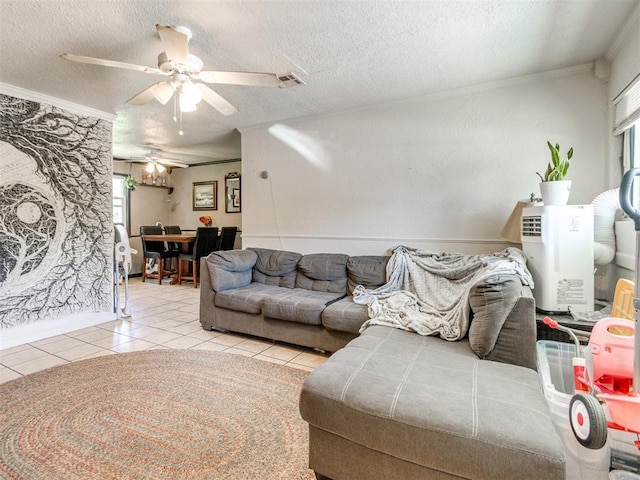 5305 S Drexel Ave, Oklahoma City, OK 73119 - tiled living area with crown molding, ceiling fan, plenty of natural light, and a textured ceiling