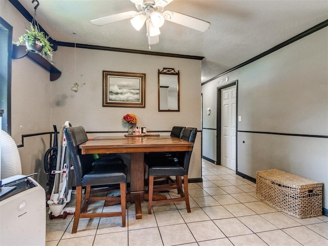 5305 S Drexel Ave, Oklahoma City, OK 73119 - dining area featuring a ceiling fan, crown molding, light tile patterned flooring, and a textured ceiling