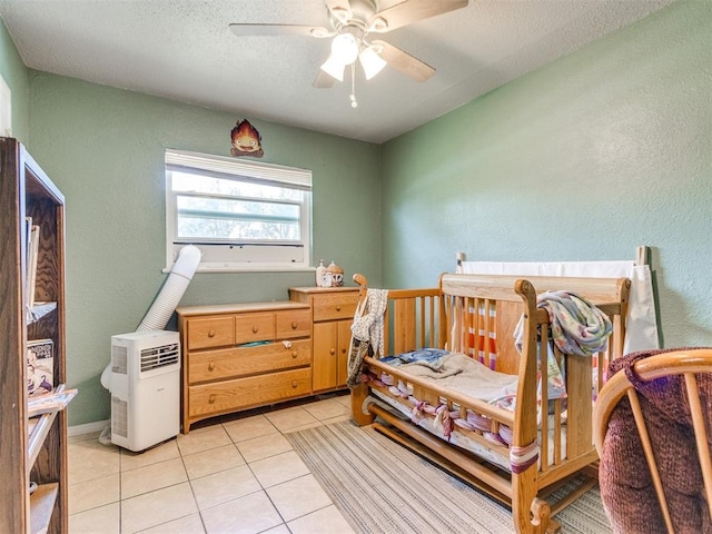 5305 S Drexel Ave, Oklahoma City, OK 73119 - bedroom featuring light tile patterned floors, a textured wall, ceiling fan, and a textured ceiling