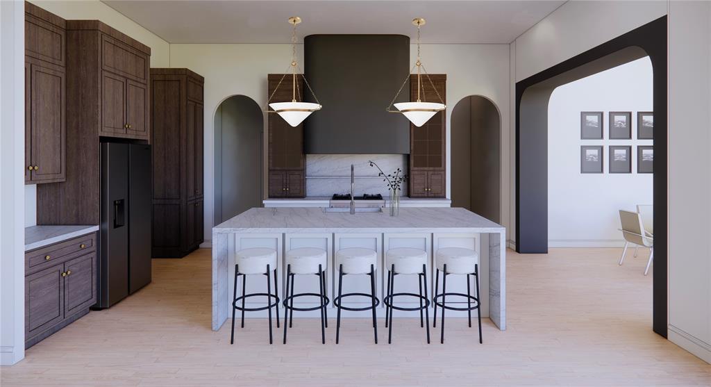 10808 NW 25th St, Yukon, OK 73099 - kitchen featuring arched walkways, black fridge, tasteful backsplash, a kitchen bar, and light wood-style flooring