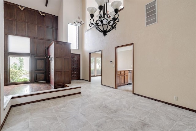 1615 Fox Hollow Rdg, Oklahoma City, OK 73131 - entryway featuring a high ceiling, a chandelier, and plenty of natural light