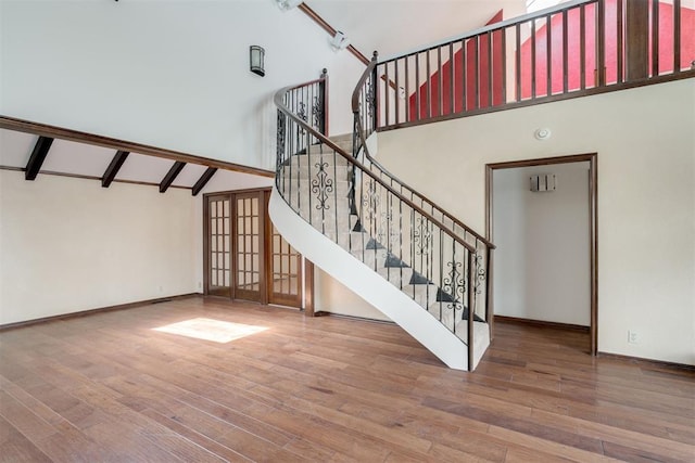 1615 Fox Hollow Rdg, Oklahoma City, OK 73131 - stairway with high vaulted ceiling, wood finished floors, and beam ceiling