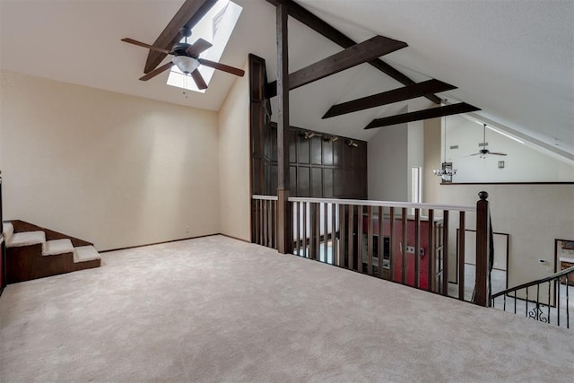 1615 Fox Hollow Rdg, Oklahoma City, OK 73131 - carpeted empty room with a ceiling fan, high vaulted ceiling, beamed ceiling, and a skylight