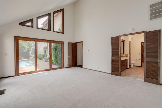 1615 Fox Hollow Rdg, Oklahoma City, OK 73131 - unfurnished living room with high vaulted ceiling and light carpet