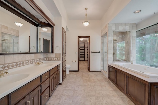 1615 Fox Hollow Rdg, Oklahoma City, OK 73131 - bathroom with a shower stall, a bath, double vanity, tasteful backsplash, and a closet