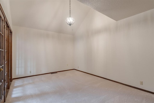 1615 Fox Hollow Rdg, Oklahoma City, OK 73131 - empty room with carpet, high vaulted ceiling, and a textured ceiling