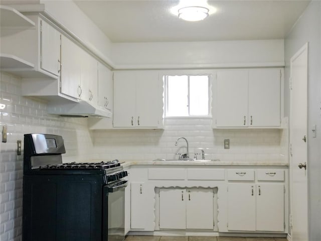 601 SE 70th St, Oklahoma City, OK 73149 - kitchen featuring black range with gas cooktop, light countertops, backsplash, and white cabinetry