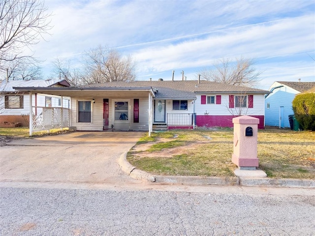 601 SE 70th St, Oklahoma City, OK 73149 - ranch-style home featuring a porch, driveway, and a carport