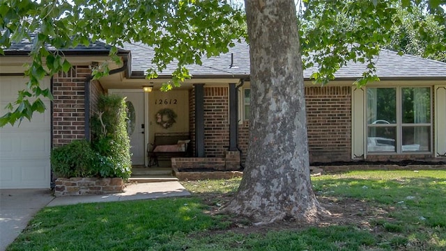 12612 Bannockburn Pl, Oklahoma City, OK 73142 - view of front of property featuring an attached garage, brick siding, and roof with shingles