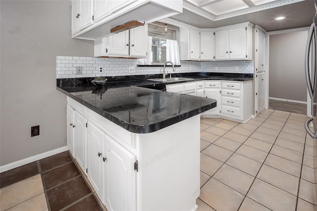 12612 Bannockburn Pl, Oklahoma City, OK 73142 - kitchen featuring a peninsula, white cabinetry, tasteful backsplash, and light tile patterned floors