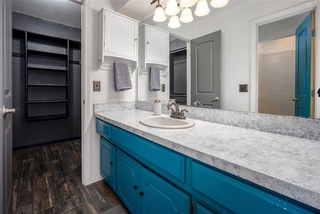 12612 Bannockburn Pl, Oklahoma City, OK 73142 - bathroom featuring vanity, wood finished floors, and a chandelier