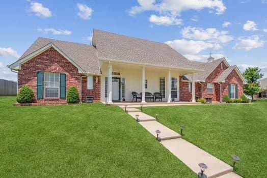 11416 Leslie Beachler Ln, Midwest City, OK 73130 - view of front facade with brick siding and a front yard