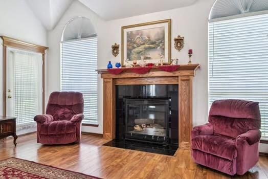 11416 Leslie Beachler Ln, Midwest City, OK 73130 - sitting room featuring a fireplace with flush hearth, wood finished floors, and lofted ceiling