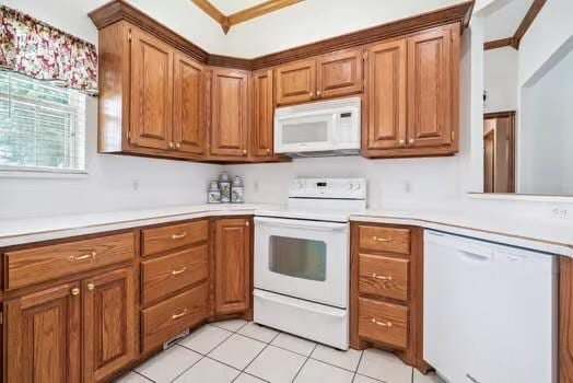 11416 Leslie Beachler Ln, Midwest City, OK 73130 - kitchen with white appliances, light countertops, and brown cabinets