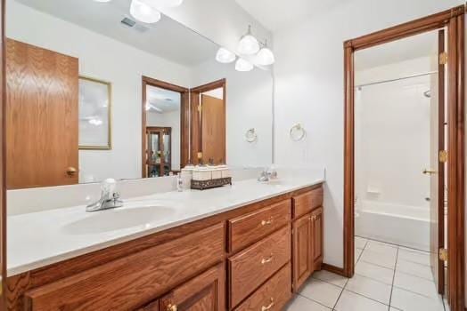 11416 Leslie Beachler Ln, Midwest City, OK 73130 - bathroom featuring double vanity, tile patterned flooring, and  shower combination