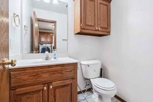 11416 Leslie Beachler Ln, Midwest City, OK 73130 - half bathroom featuring vanity, washer / dryer, and tile patterned flooring