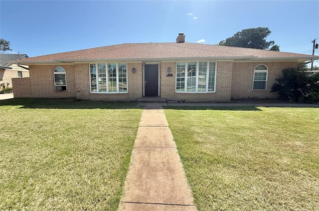 2501 Seminole Cir, Altus, OK 73521 - ranch-style house featuring brick siding, a front lawn, and a chimney