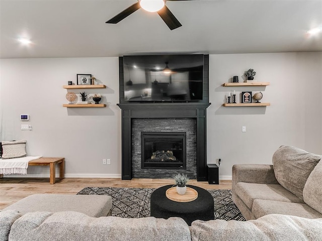 15109 Caspian Ln, Edmond, OK 73013 - living room featuring a ceiling fan, wood finished floors, and a fireplace