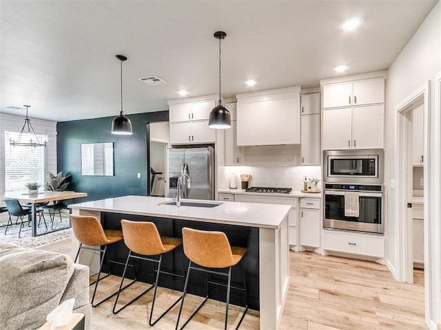 15109 Caspian Ln, Edmond, OK 73013 - kitchen with stainless steel appliances, light countertops, tasteful backsplash, white cabinetry, and recessed lighting