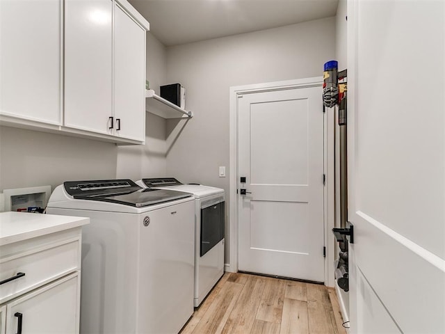 15109 Caspian Ln, Edmond, OK 73013 - laundry area with washing machine and clothes dryer, light wood finished floors, and cabinet space
