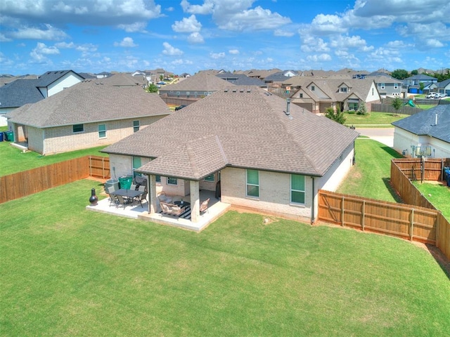 15109 Caspian Ln, Edmond, OK 73013 - back of house featuring a residential view, a shingled roof, a fenced backyard, a patio, and brick siding