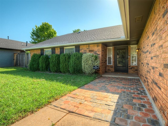 1008 S Neptune Rd, Edmond, OK 73003 - view of exterior entry with a lawn and brick siding