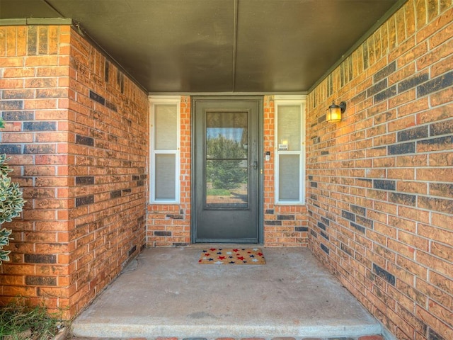 1008 S Neptune Rd, Edmond, OK 73003 - doorway to property featuring brick siding