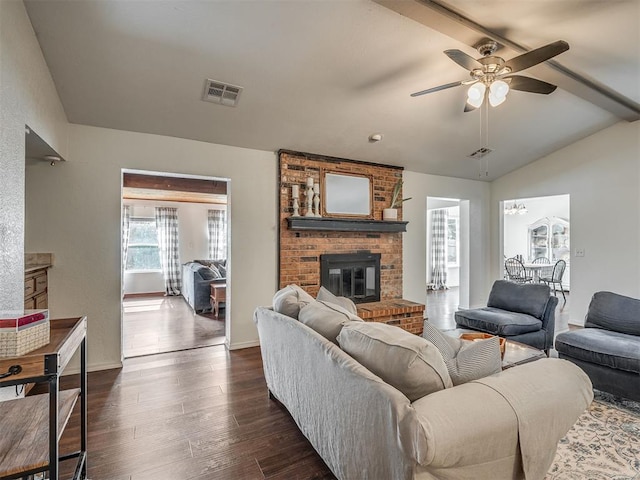1008 S Neptune Rd, Edmond, OK 73003 - living room with a brick fireplace, ceiling fan, and dark wood finished floors