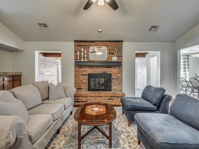 1008 S Neptune Rd, Edmond, OK 73003 - living room featuring a ceiling fan, plenty of natural light, and a brick fireplace