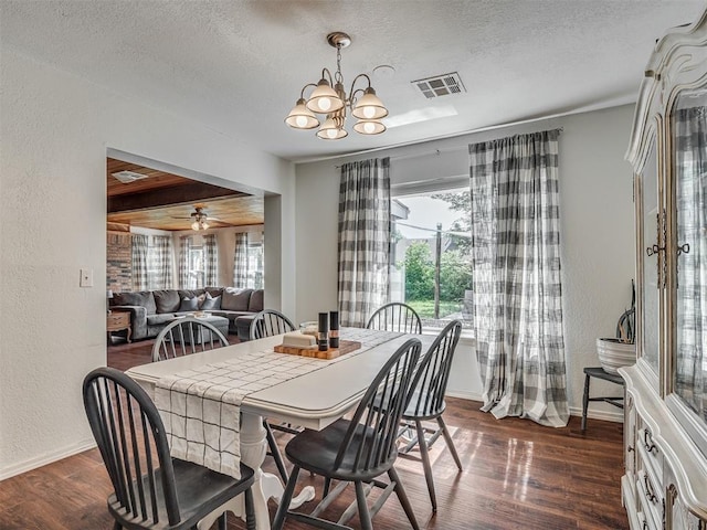 1008 S Neptune Rd, Edmond, OK 73003 - dining area with a textured wall, a textured ceiling, plenty of natural light, dark wood-style flooring, and a chandelier