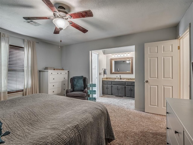 1008 S Neptune Rd, Edmond, OK 73003 - bedroom with light carpet, ensuite bath, a textured ceiling, and a ceiling fan
