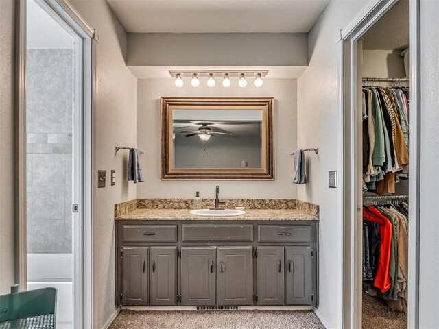 1008 S Neptune Rd, Edmond, OK 73003 - full bathroom featuring vanity, a spacious closet, and ceiling fan
