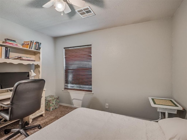 1008 S Neptune Rd, Edmond, OK 73003 - carpeted bedroom featuring a desk, ceiling fan, and a textured ceiling