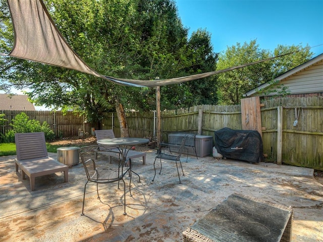 1008 S Neptune Rd, Edmond, OK 73003 - fenced backyard featuring a patio, grilling area, and outdoor dining area