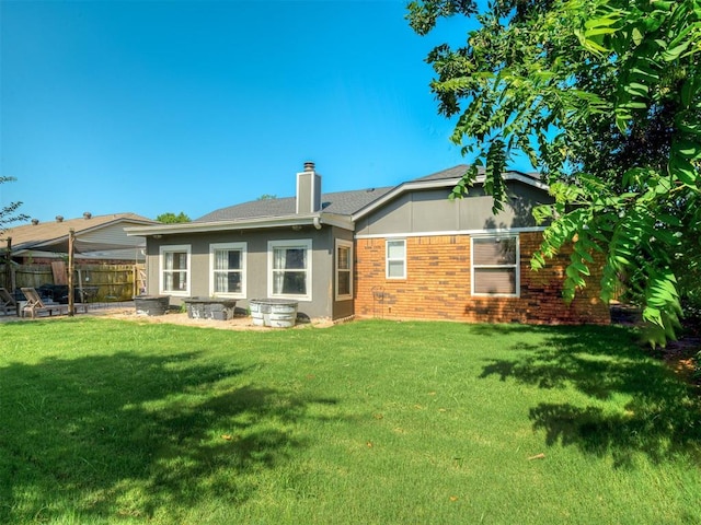 1008 S Neptune Rd, Edmond, OK 73003 - rear view of house with brick siding and a chimney
