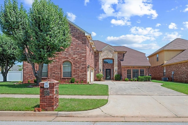 125 NW 147th St, Edmond, OK 73013 - view of front of house with driveway, brick siding, and a garage