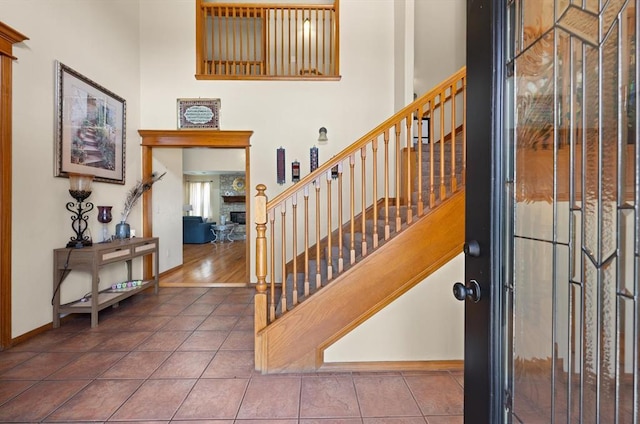 125 NW 147th St, Edmond, OK 73013 - tiled entrance foyer featuring stairs, a fireplace, and a towering ceiling