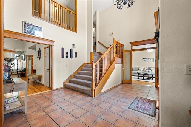 125 NW 147th St, Edmond, OK 73013 - stairway with a towering ceiling, tile patterned flooring, and a chandelier