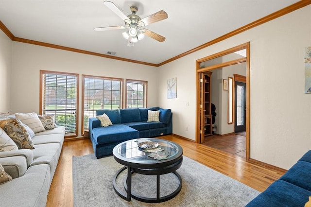 125 NW 147th St, Edmond, OK 73013 - living area featuring wood finished floors, ornamental molding, and ceiling fan