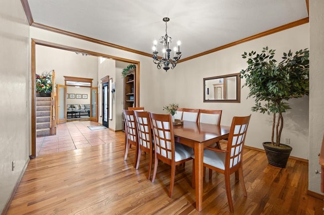 125 NW 147th St, Edmond, OK 73013 - dining room with a chandelier, light wood-type flooring, and ornamental molding