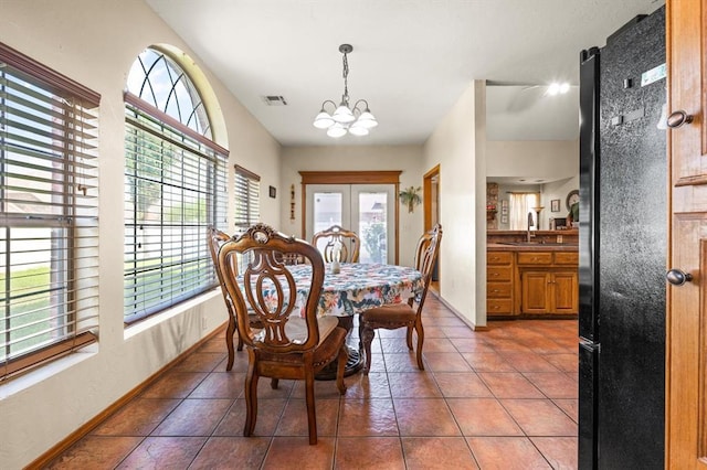 125 NW 147th St, Edmond, OK 73013 - dining room featuring plenty of natural light, a chandelier, and tile patterned floors